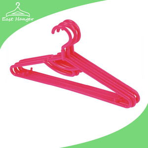 Easy red plastic pant hanger with hang slot and trousers bar and nails for strap and a swivel hook